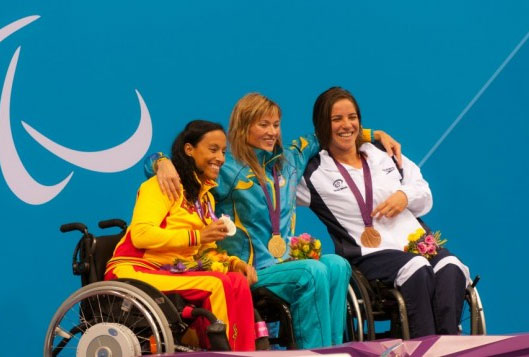 Israeli swimmer Inbal Pezaro, right, holds the bronze medal she won in the 50 meter freestyle event