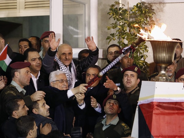 Palestinian President Mahmoud Abbas lights a torch to welcome Palestinian terrorists released from Israeli prisons, Dec 2013