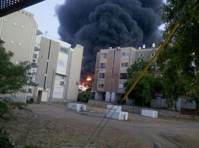 Smoke rises from burning factory in Sderot struck by rocket fire