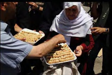 Sweets are handed out in Gaza to celebrate the kidnapping