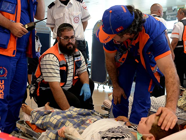 Israeli paramedics treating wounded Palestinian at Erez Crossing