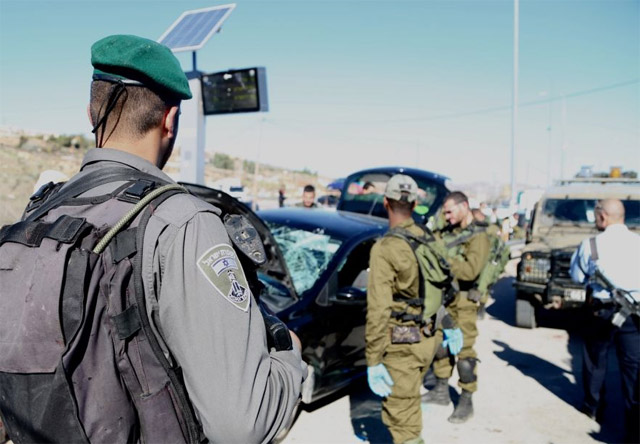 Border Police officers and IDF soldiers arrive on the scene of car ramming attack at Tapuach Junction