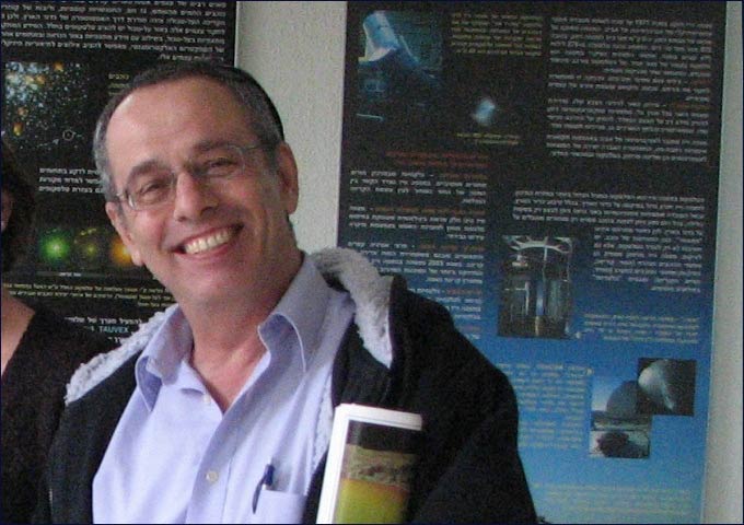 Prof. Alpert holding satellite maps and international newspapers that reprinted his findings on global pollution levels