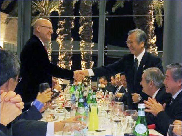 Yoshiyu Nakamura, head of Japan's Keidanren business federation, shaking hands with Roni Bernstein, head of the Japan-Israel Chamber of Commerce