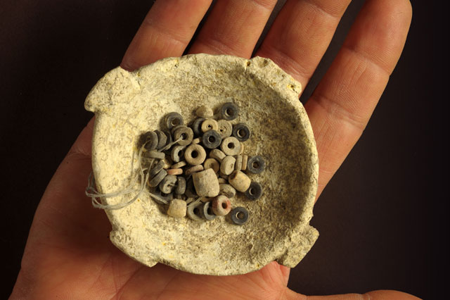 String of colored beads in a bowl from the Stone Age