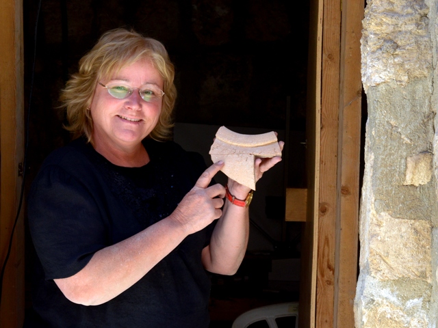 Dr. Mazar displays a 10th century BCE jar fragment unearthed near Jerusalem's Temple Mount bearing an inscription in Canaanite