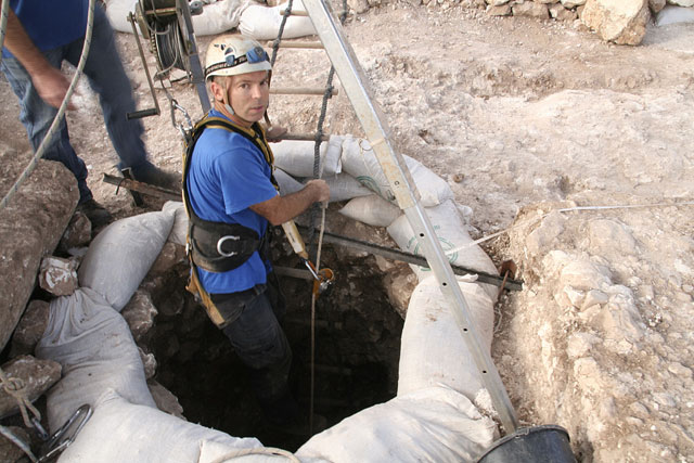 Israel Antiquities Authority worker enters the well