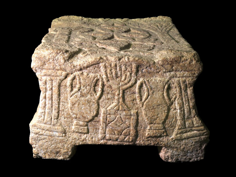 The stone with the menorah symbol which was discovered in the synagogue at Magdala.