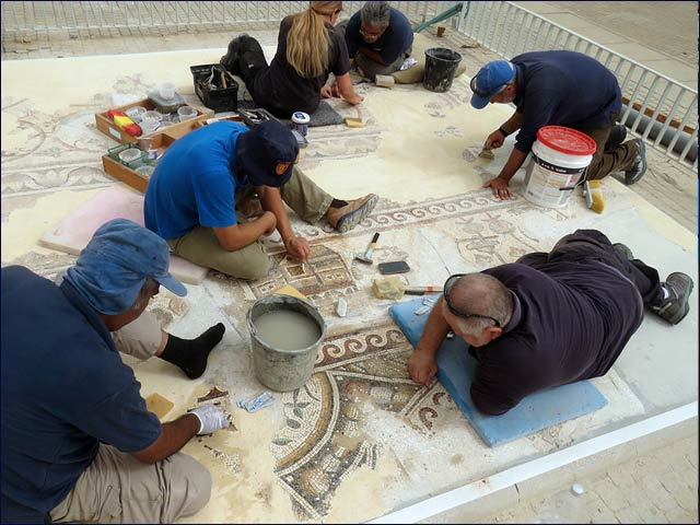 Workers of the Israel Antiquities Authority conserving the mosaic.