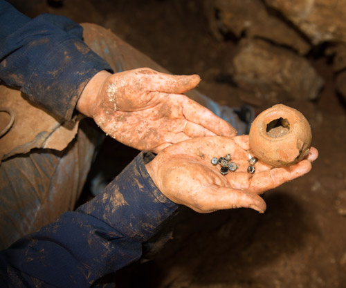 Agate stones that were part of a string of beads and the Hellenistic oil lamp in which the stones were kept