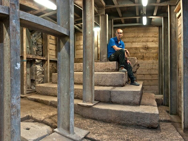 Co-director Dr. Joe Uziel seated on the stepped structure from the Second Temple period