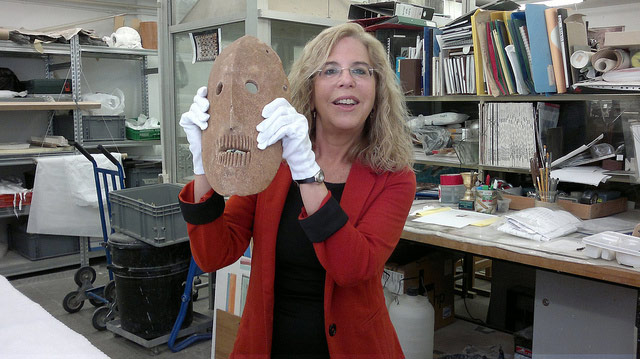 Dr. Debby Hershman displaying one of the ancient masks