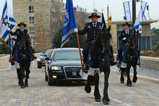 President Peres is escorted to the opening of the Knesset