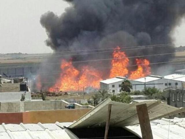 A rocket fired from Gaza fell short and exploded at the UNRWA warehouses causing a massive fire