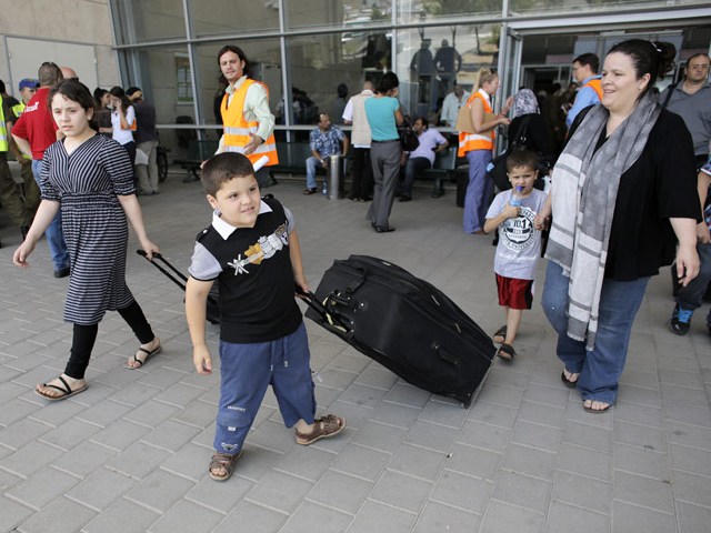 Palestinians walk out of Israel's Erez Crossing after leaving Gaza, July 13, 2014