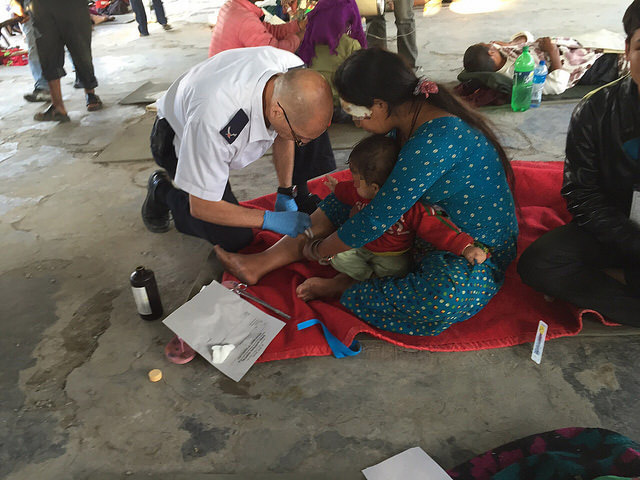 Member of MDA team treats the wounded in the field