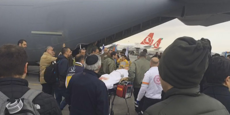 One of the Israeli wounded is loaded onto the plane to return to Israel