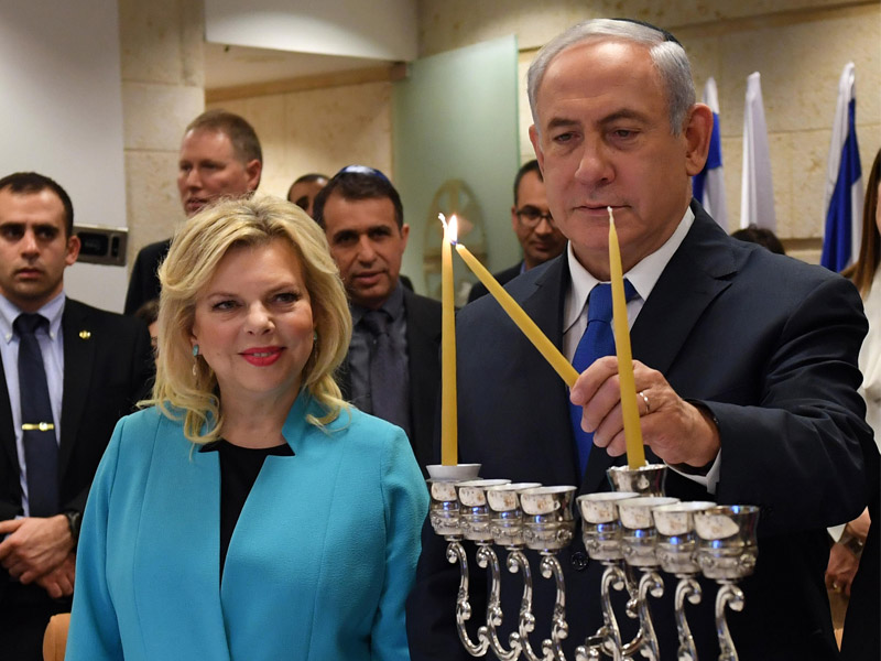 PM Netanyahu and his wife Sara lighting the first Chanukah candle at the MFA ceremony.