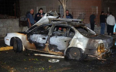 Remains of a car hit by a rocket in Beersheba