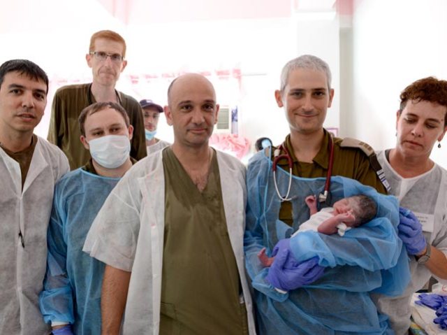 Israeli doctors with first Philippine baby born in field hospital