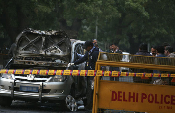 Police examine damaged Israeli embassy car after explosion in New Delhi