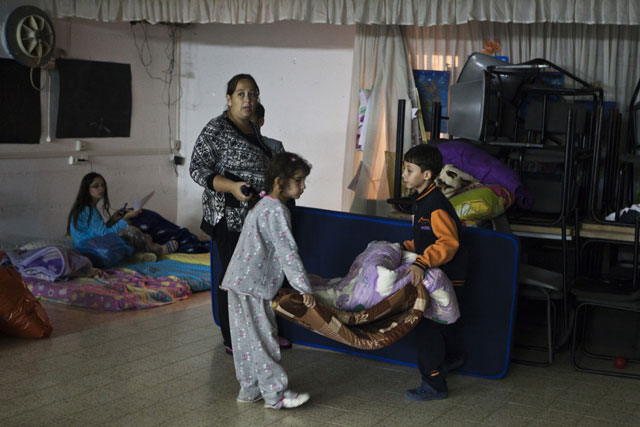 Israelis prepare to sleep in a bomb shelter in the southern town of Netivot