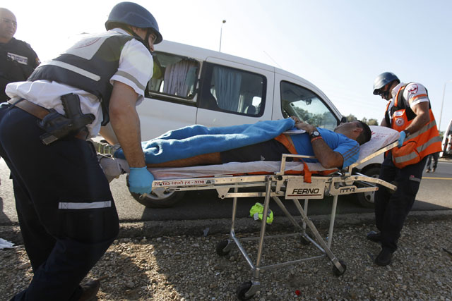 Israeli medics transport a man wounded by a rocket fired from Gaza near Sderot, Nov 11, 2012