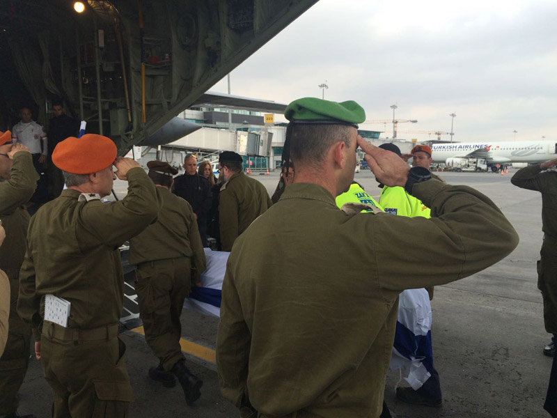 IDF soldiers salute as the coffins of the victims of the Istanbul terror attack are loaded onto the plane to return to Israel