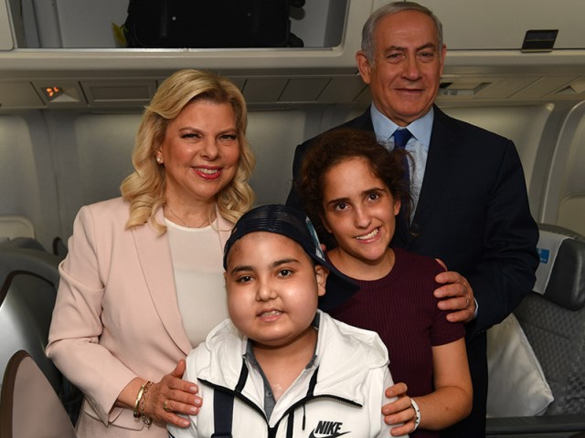 PM Netanyahu and his wife Sara with Mika Lipsker and Alon Eizarayev, who are accompanying them on the trip to Moscow.