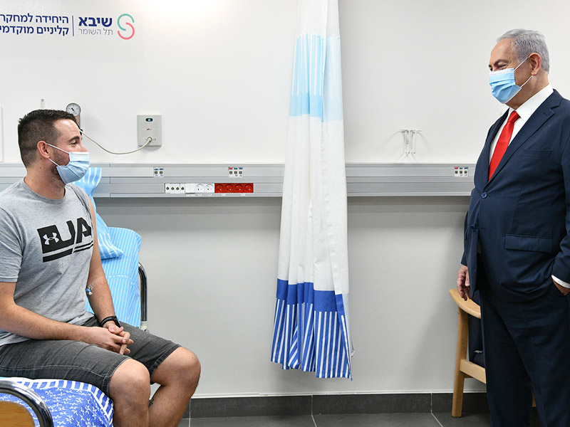 PM Netanyahu with Segev Harel the first volunteer in the COVID-19 vaccine-testing program.