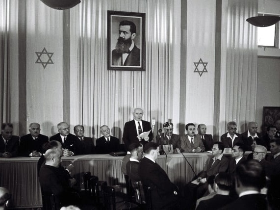 DAVID BEN GURION READING THE DECLARATION OF THE INDEPENDENCE OF ISRAEL IN THE MUSEUM IN TEL AVIV.