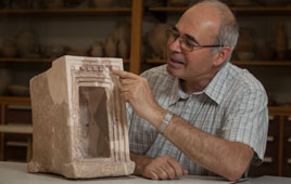 Professor Yodef Garfinkel with a model of shrine afound at Khirbet Qeiyafa