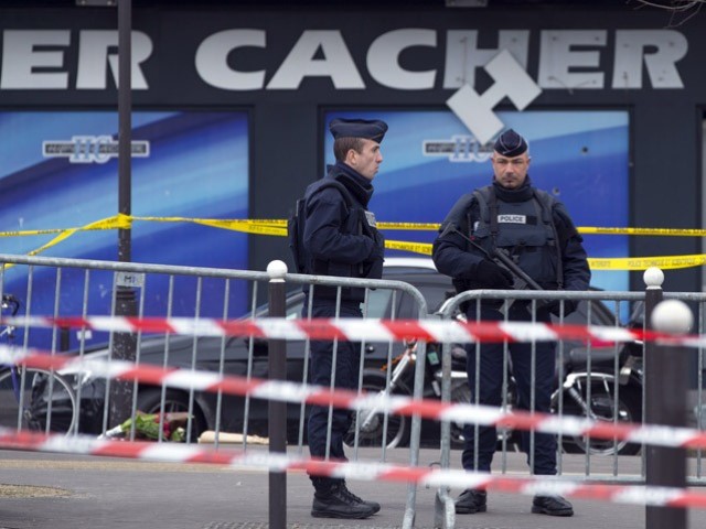 French police officers stand guard outside the Hyper Cacher supermarket in Paris