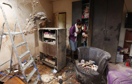 Tami Shadadi surveys the damage to her house in Sderot (Nov 12, 2012), after it was hit by a rocket fired by Palestinian terrorists in Gaza (Photo: Reuters)